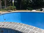 Gunite swimming pool with granite brick style coping
